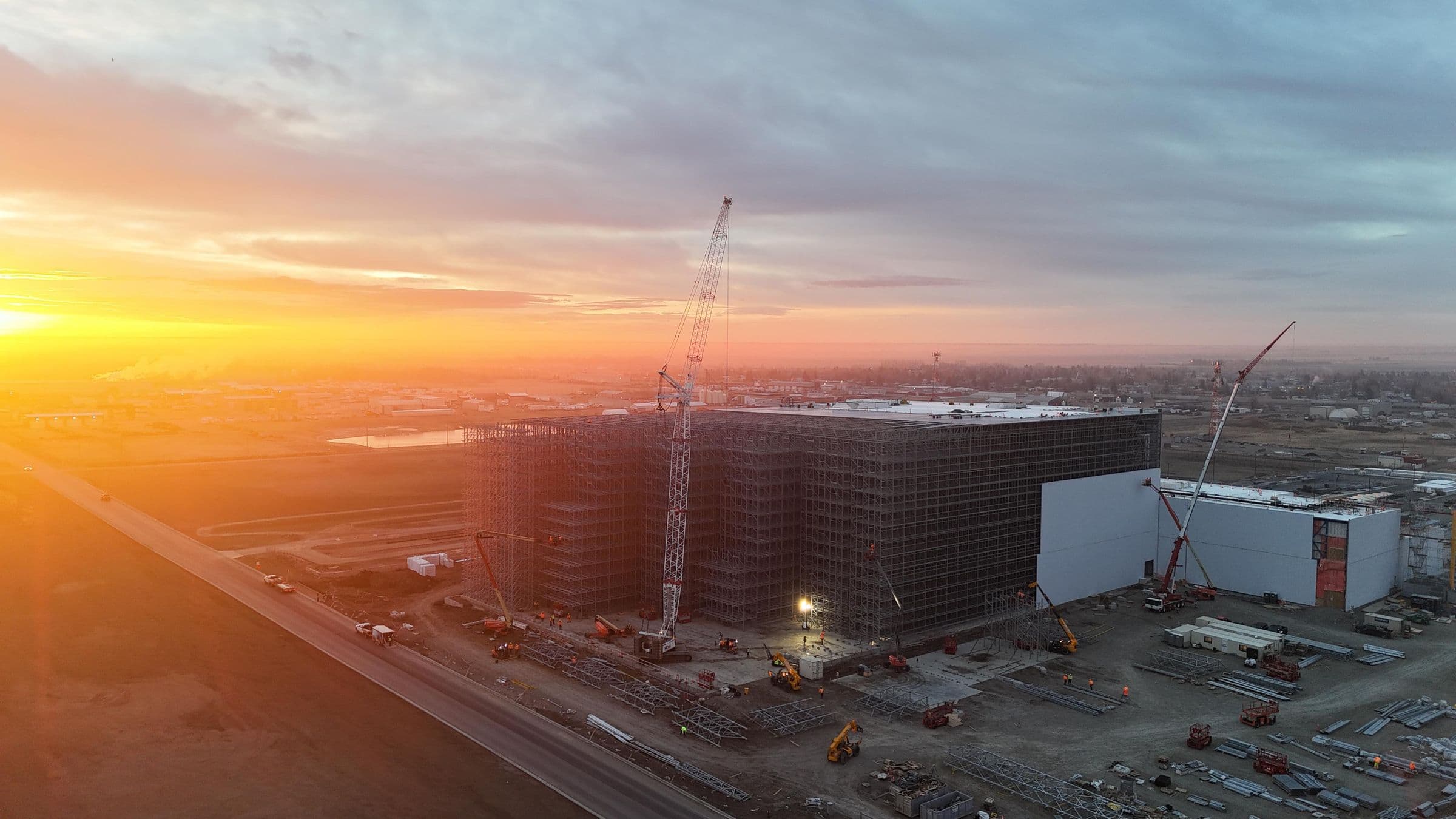 Aerial view under an orange sky of the NewCold facility in Coaldale with the new industrial rail spur alongside
